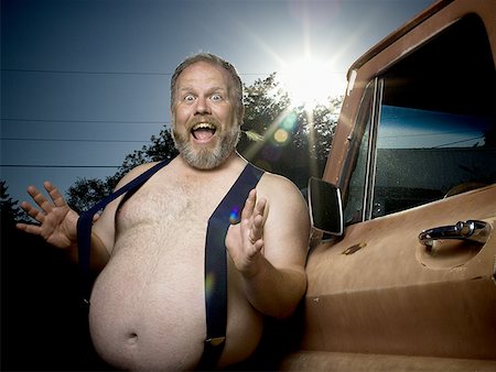 fat men in suspenders - Overweight man with suspenders by truck Foto de stock - Sin royalties Premium, Código: 640-01353603