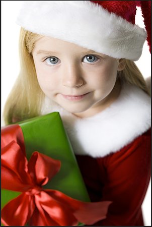 Portrait of a girl holding a Christmas present Stock Photo - Premium Royalty-Free, Code: 640-01353627