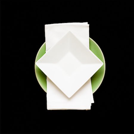 square plate - Square plate on napkin with round plate underneath Stock Photo - Premium Royalty-Free, Code: 640-01353632