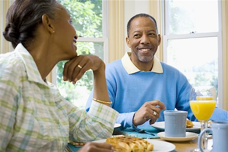 Senior man and a senior woman sitting at the breakfast table Stock Photo - Premium Royalty-Free, Code: 640-01353701