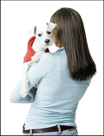 dog person white background - Rear view of a young woman holding a dog in her arms Stock Photo - Premium Royalty-Free, Code: 640-01353720