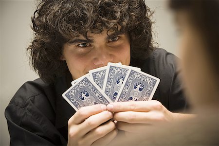 simsearch:640-01365454,k - Close-up of a teenage boy holding cards Stock Photo - Premium Royalty-Free, Code: 640-01353817