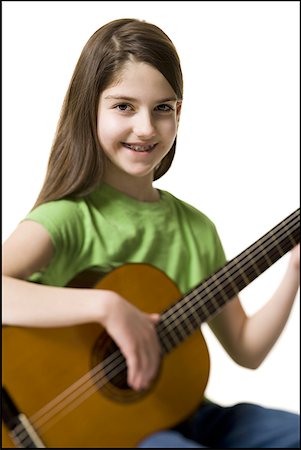 simsearch:640-02772211,k - Girl with braces playing guitar smiling Foto de stock - Sin royalties Premium, Código: 640-01353819