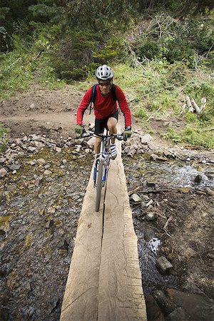 pictures of tributary waters - High angle view of a mature man riding a bicycle Stock Photo - Premium Royalty-Free, Code: 640-01353877