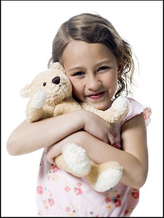 Portrait d'une jeune fille embrassant un ours en peluche Photographie de stock - Premium Libres de Droits, Code: 640-01353871