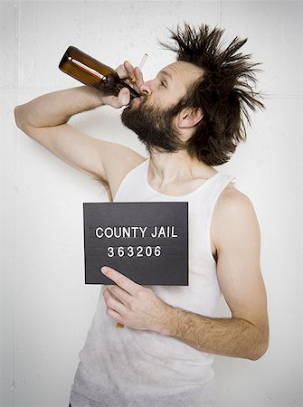 picture of drunk man with beard - Man drinking beer holding blank sign and cigarette Stock Photo - Premium Royalty-Free, Code: 640-01353880