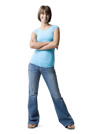 female jeans and slippers - Portrait of a teenage girl smiling with her arms crossed Stock Photo - Premium Royalty-Free, Code: 640-01353891