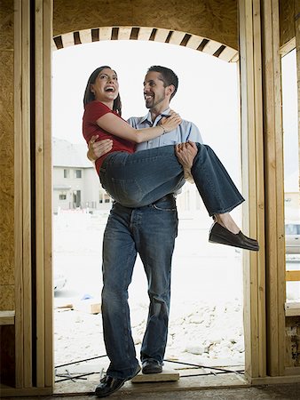 Young man carrying a young woman Stock Photo - Premium Royalty-Free, Code: 640-01353893