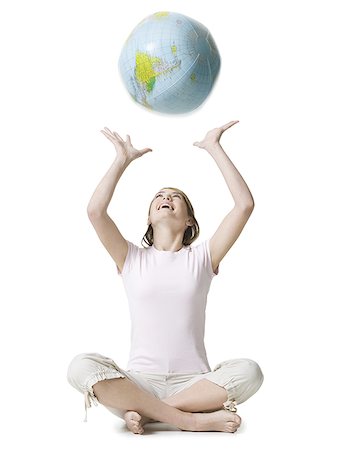 Girl playing with a globe Stock Photo - Premium Royalty-Free, Code: 640-01353904