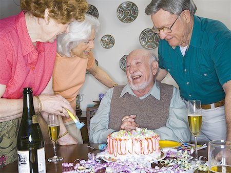 senior woman with cake - Two senior couples smiling at a birthday party Stock Photo - Premium Royalty-Free, Code: 640-01353909