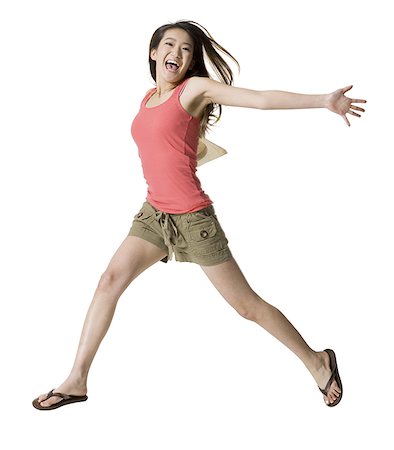 simsearch:640-01359391,k - Portrait of a young woman jumping Foto de stock - Royalty Free Premium, Número: 640-01353954