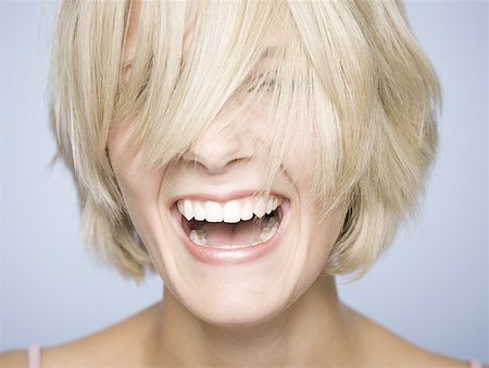 Portrait of a young woman laughing Stock Photo - Premium Royalty-Free, Code: 640-01353988