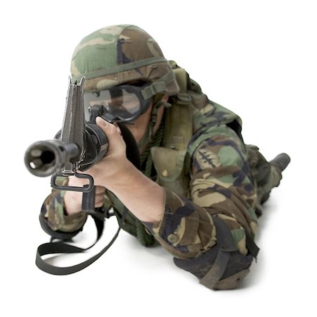 Close-up of a soldier lying down and aiming his rifle Stock Photo - Premium Royalty-Free, Code: 640-01353990