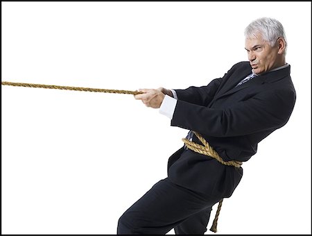 Businessman in a tug of war Stock Photo - Premium Royalty-Free, Code: 640-01364019