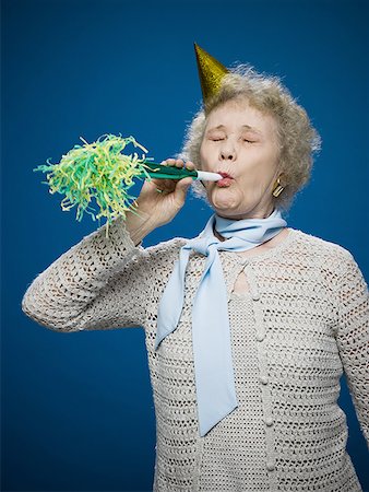 simsearch:693-07444529,k - Older woman with noisemaker and party hat Stock Photo - Premium Royalty-Free, Code: 640-01364045