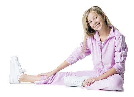 Portrait of a teenage girl exercising on the floor Stock Photo - Premium Royalty-Free, Code: 640-01364114