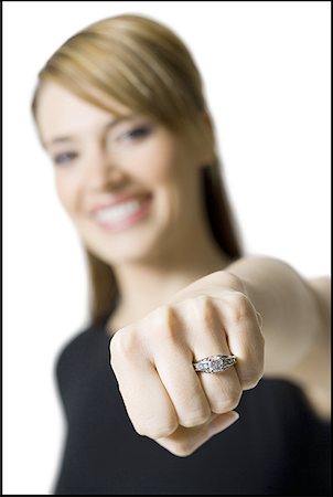 Portrait of a young woman showing her ring Stock Photo - Premium Royalty-Free, Code: 640-01364125