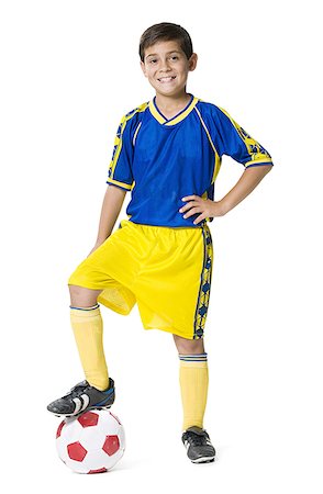 soccer boy length - Portrait of a boy resting his foot on a soccer ball Stock Photo - Premium Royalty-Free, Code: 640-01364242