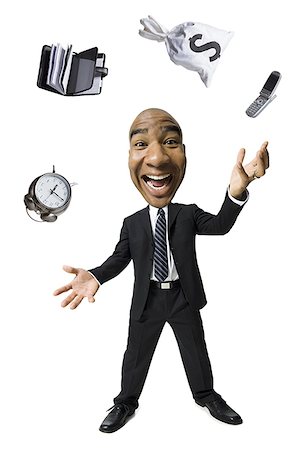 funny faces african american - Businessman juggling different tasks Stock Photo - Premium Royalty-Free, Code: 640-01364273