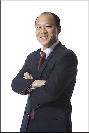 président (directeur) - Portrait d'un homme d'affaires permanent avec ses bras repliés et souriant Photographie de stock - Premium Libres de Droits, Code: 640-01364338