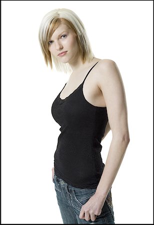simsearch:640-01365857,k - Portrait of a young woman standing with her hands in her pockets Stock Photo - Premium Royalty-Free, Code: 640-01364363