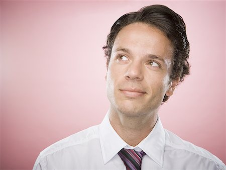 Close-up of a businessman looking up Stock Photo - Premium Royalty-Free, Code: 640-01364594