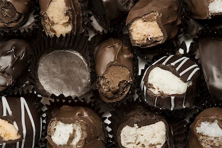 Close-up of a box of half eaten chocolates Stock Photo - Premium Royalty-Free, Code: 640-01364591