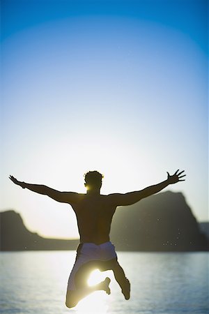 simsearch:640-01366168,k - Rear view of a young man diving in a lake Foto de stock - Royalty Free Premium, Número: 640-01364657