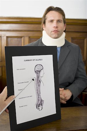 Close-up of an exhibit of evidence in front of a victim in a courtroom Stock Photo - Premium Royalty-Free, Code: 640-01364670