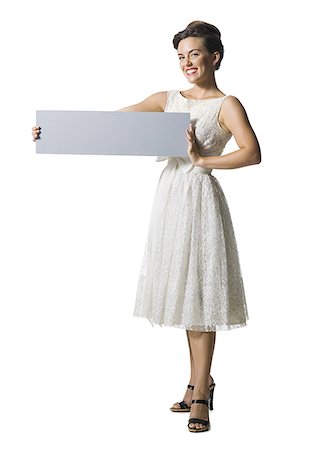 simsearch:640-01355807,k - Woman in white dress holding a blank sign Foto de stock - Sin royalties Premium, Código: 640-01364803
