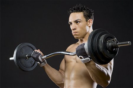 simsearch:640-01355937,k - Close-up of a mid adult man lifting a barbell Foto de stock - Sin royalties Premium, Código: 640-01364835