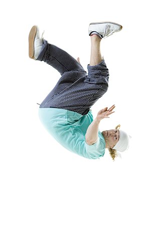 Profile of a young man doing a back flip Stock Photo - Premium Royalty-Free, Code: 640-01364837