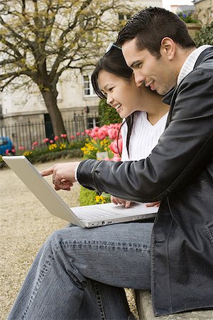 Young couple working on a laptop Stock Photo - Premium Royalty-Free, Code: 640-01364853