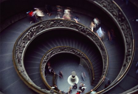 spiral staircase people - High angle view of people walking on a spiral staircase Stock Photo - Premium Royalty-Free, Code: 640-01364927