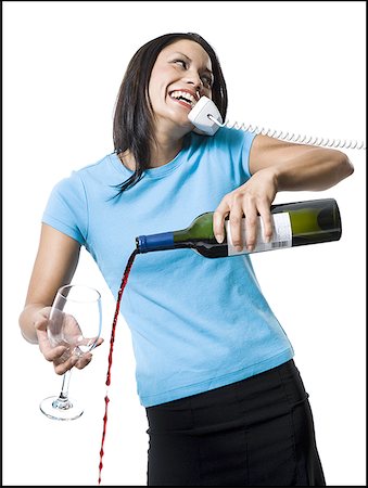 female clumsy - Distracted woman pouring red wine and missing glass Stock Photo - Premium Royalty-Free, Code: 640-01364934