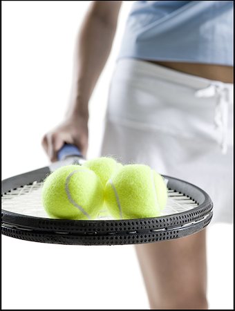 simsearch:640-01359251,k - Milieu vue en coupe d'une jeune femme tenant une raquette de tennis avec trois balles de tennis Photographie de stock - Premium Libres de Droits, Code: 640-01364940