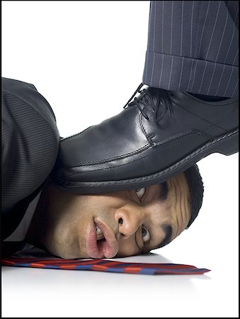 Businessman lying down being stepped on Foto de stock - Sin royalties Premium, Código: 640-01365018