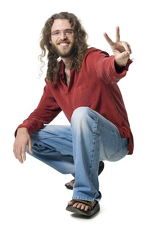 portrait hippies - Man with long hair and beard making peace gesture Stock Photo - Premium Royalty-Free, Code: 640-01365028