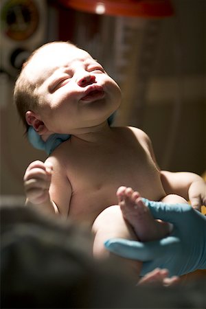 Person's hand holding a baby's foot Stock Photo - Premium Royalty-Free, Code: 640-01365054