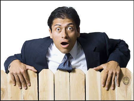 simsearch:640-02771261,k - Businessman looking over wooden fence Stock Photo - Premium Royalty-Free, Code: 640-01365071