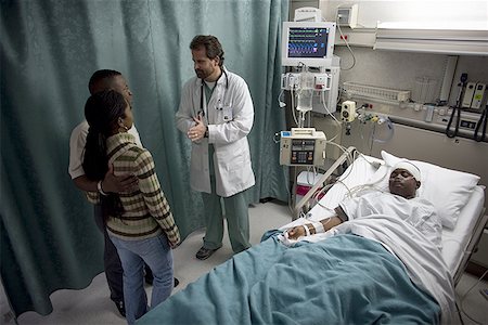 pictures of a sad man sleeping - High angle view of a patient lying on the bed with his father and mother talking to a male doctor Stock Photo - Premium Royalty-Free, Code: 640-01365116