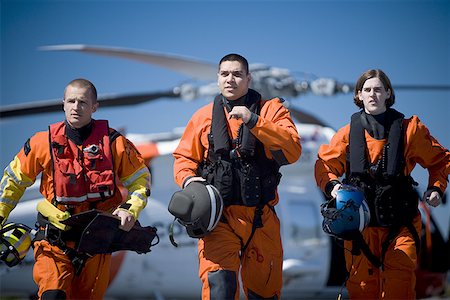 Coast guard workers in uniforms with helicopter Stock Photo - Premium Royalty-Free, Code: 640-01365149