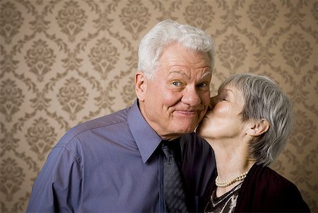 portrait of bald woman - Close-up of an elderly woman kissing an elderly man Stock Photo - Premium Royalty-Free, Code: 640-01365157