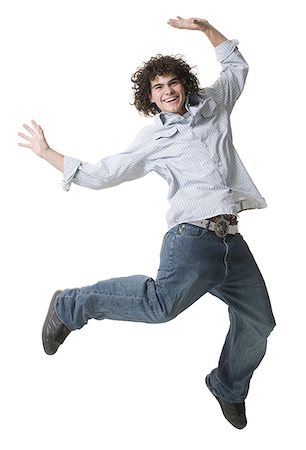 Portrait of a teenage boy jumping in mid-air Stock Photo - Premium Royalty-Free, Code: 640-01365187