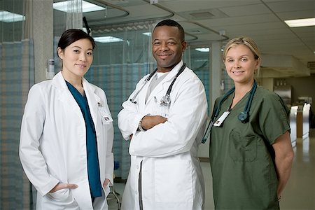 simsearch:640-01363966,k - Portrait of a male doctor and two female doctors smiling Stock Photo - Premium Royalty-Free, Code: 640-01365217