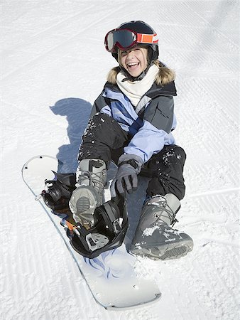 snow face goggles - Portrait of a girl putting on a snowboard Stock Photo - Premium Royalty-Free, Code: 640-01365247