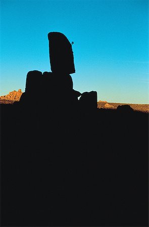 simsearch:640-01361581,k - Silhouette of a person climbing a rock formation Fotografie stock - Premium Royalty-Free, Codice: 640-01365251
