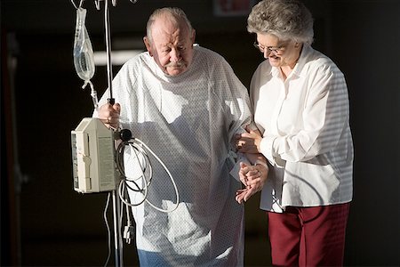 Senior woman helping a senior man walk Stock Photo - Premium Royalty-Free, Code: 640-01365265