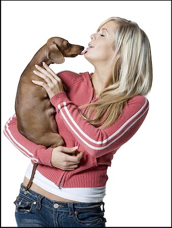 Close-up of a young woman holding a puppy Stock Photo - Premium Royalty-Free, Code: 640-01365288