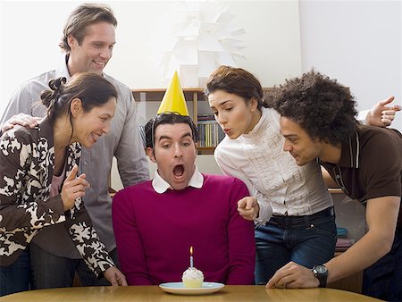 sunbathing with friends - Man wearing a birthday hat Stock Photo - Premium Royalty-Free, Code: 640-01365283